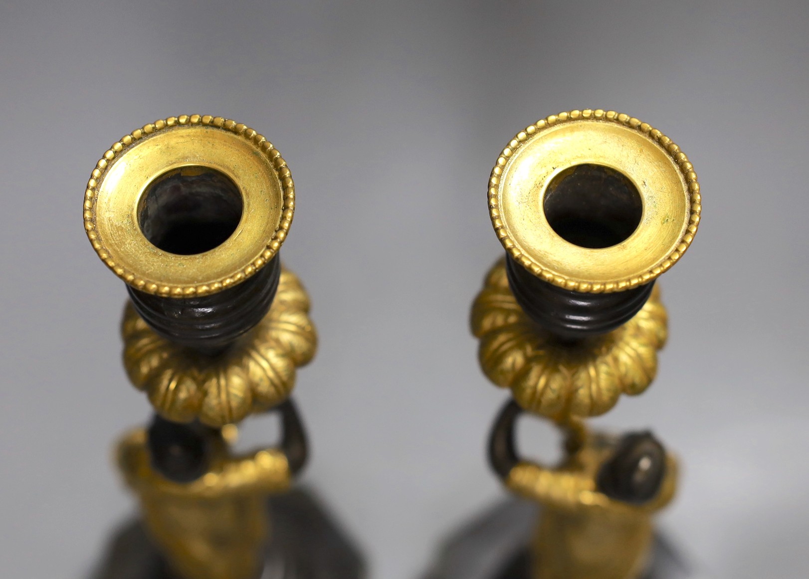 A pair of Eastern style bronze and ormolu figural candlesticks, 27cm